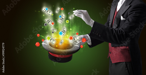 Fototapeta Naklejka Na Ścianę i Meble -  Illusionist conjure with magic wand gambling things from a cylinder