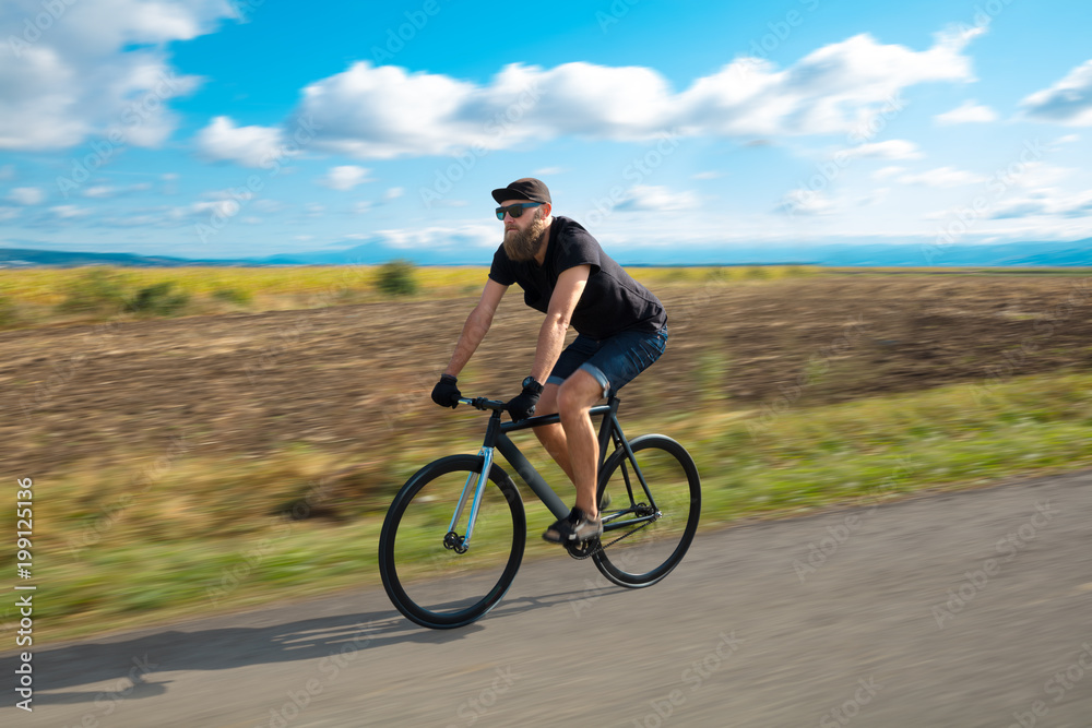Natural view with cyclist going somewhere with stylish bike Natural view with cyclist going somewhere with stylish bike