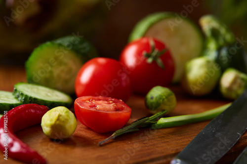 fresh vegetables on the cutting board over wooden background, selective focus, shallow depth of field