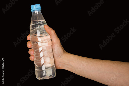 bottle with water in hand isolated on black background