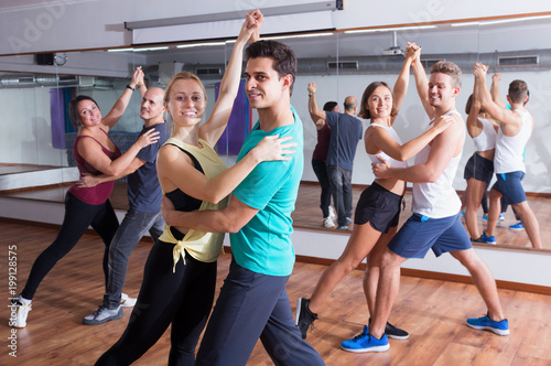 Group of energy people dancing salsa together