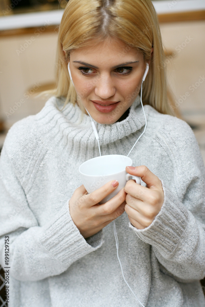 Woman holding a cup of coffee. Woman holding a cup of coffee.