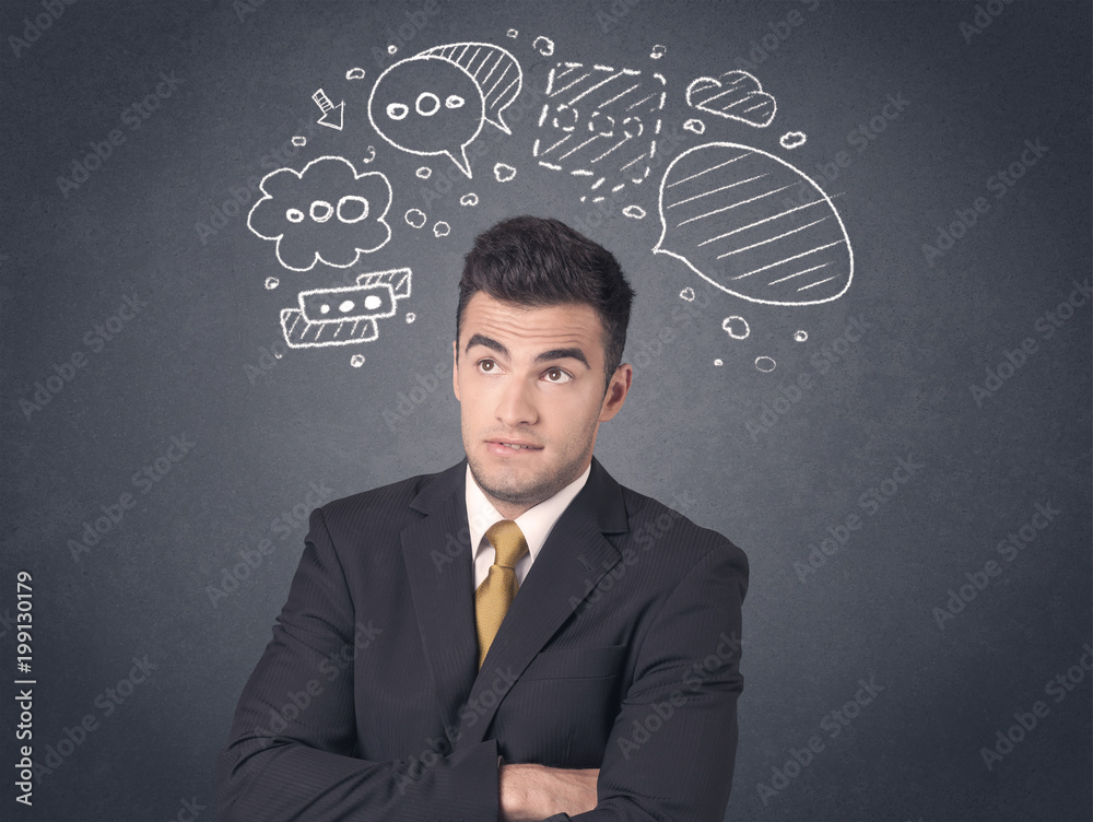 Young businessman with drawn speech bubbles over his head Young businessman with drawn speech bubbles over his head