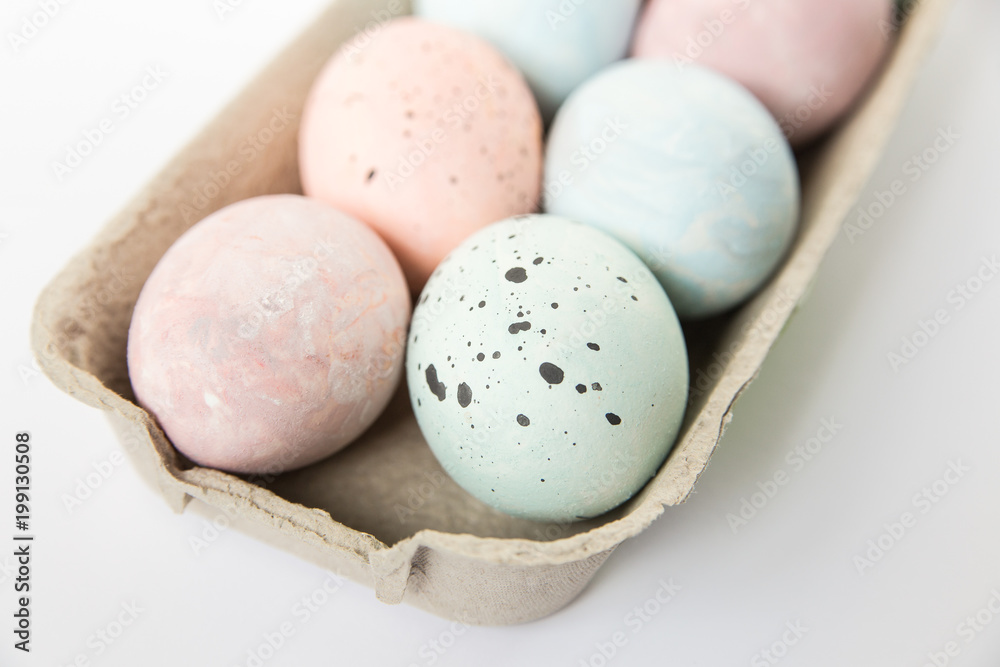 Easter eggs,painted light pastel colors in paper tray.Minimalistic stylish image.Easter background. Easter eggs,painted light pastel colors in paper tray.Minimalistic stylish image.Easter background.