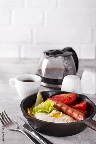 Homemade delicious american breakfast with fried egg, toast, sausage, vegetable, black coffee photo