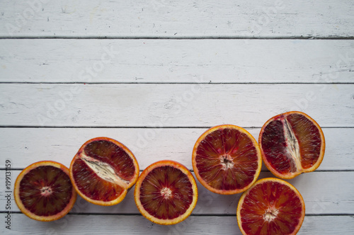 Pieces of blood orange on wooden background. photo