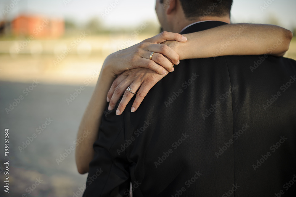 Hand of groom embracing bride Hand of groom embracing bride