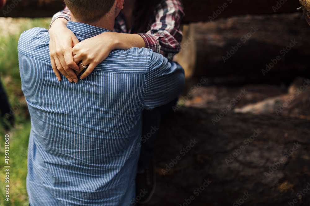 Man embracing her girlfriend by shoulder Man embracing her girlfriend by shoulder