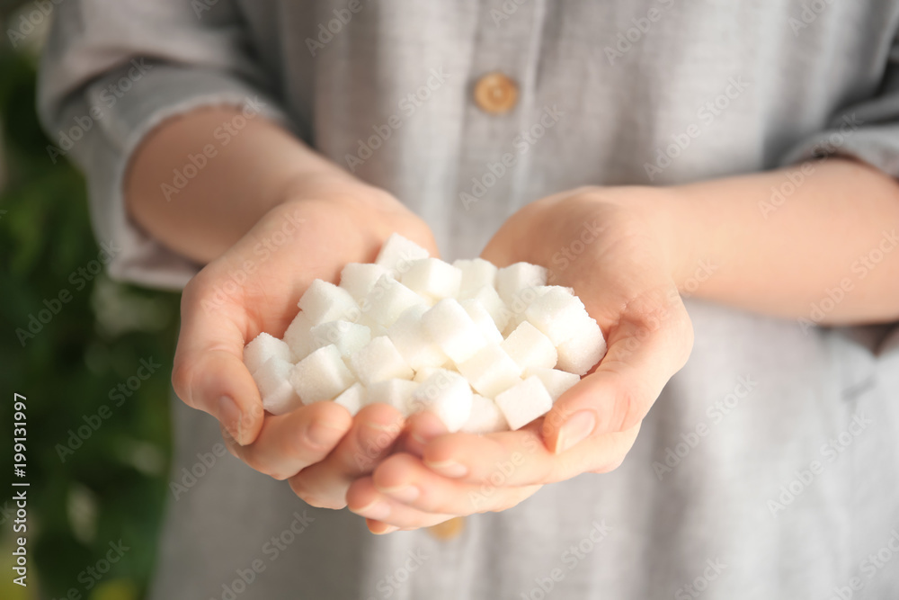 Woman holding sugar cubes, closeup Woman holding sugar cubes, closeup