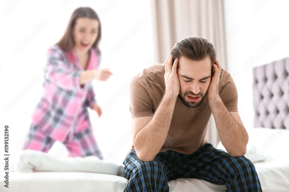 Fototapeta premium Young couple having argument in bedroom