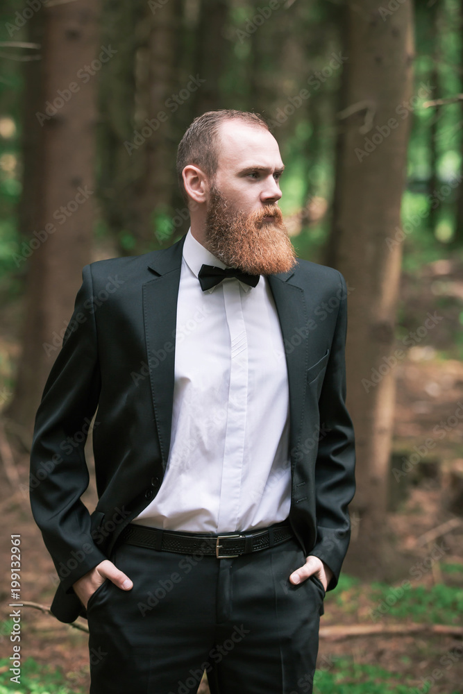 portrait of successful businessman on the background of pine forest portrait of successful businessman on the background of pine forest