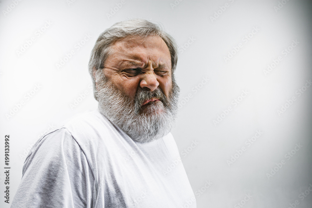 Senior man with disgusted expression repulsing something on white Senior man with disgusted expression repulsing something on white