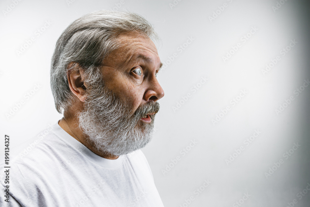 Obraz premium The senior attractive man looking suprised isolated on white