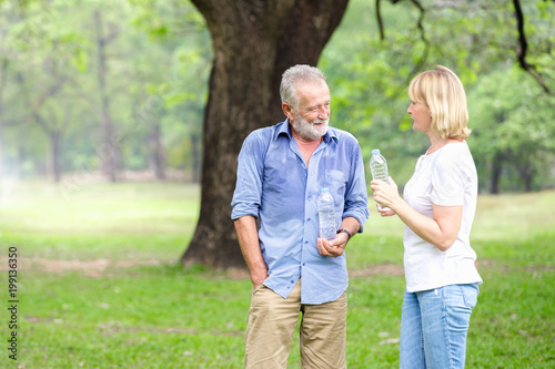 Portrait senior couple standing drinking water at the park © kasipat