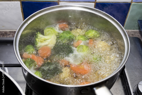 vegetables boiling in a saucepan on a hob