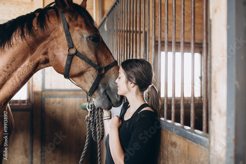 Beautiful young woman with her horse.