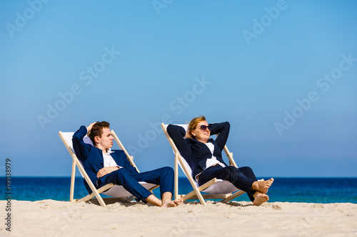 Woman and man relaxing on beach
