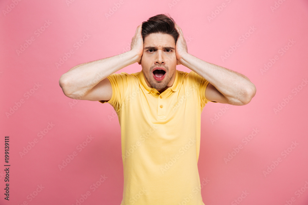Portrait of a shocked young man looking at camera Portrait of a shocked young man looking at camera