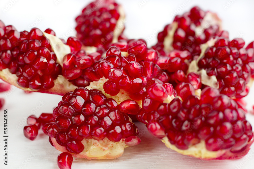 Cut-up tasty garnet fruit pomegranate with seeds on white background Cut-up tasty garnet fruit pomegranate with seeds on white background