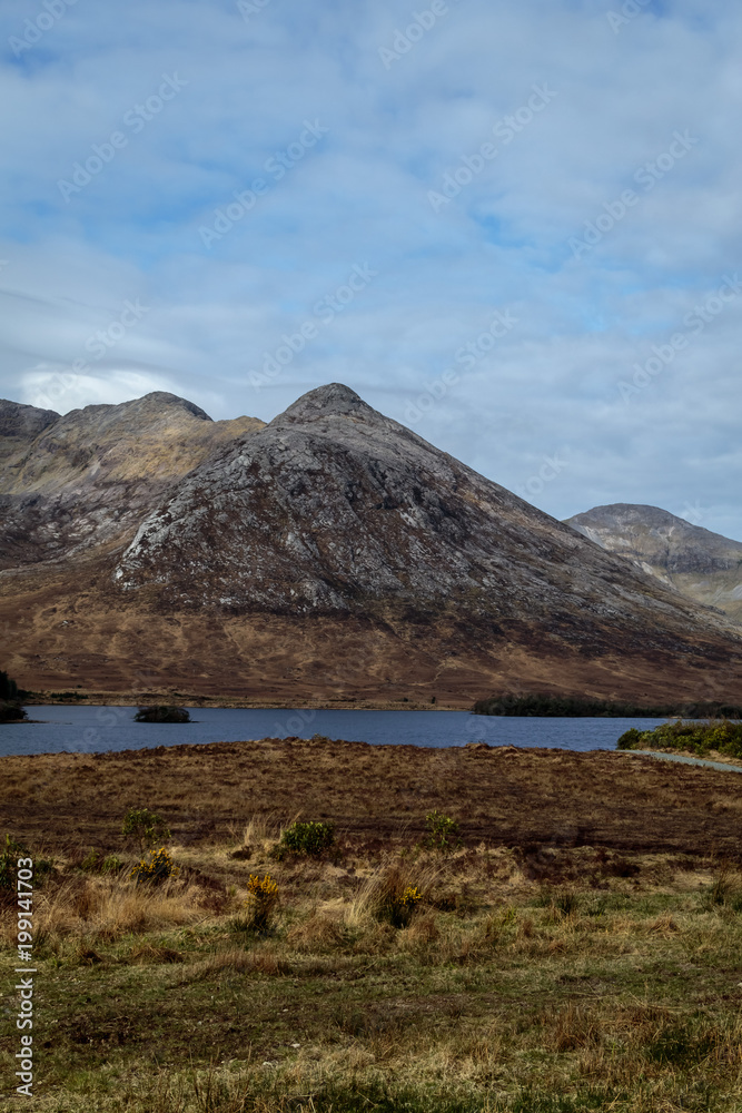 Hiking Trail in Connemara, Ireland, Blue lake on the foreground, Mountains on the Background, Sunny Winter Day