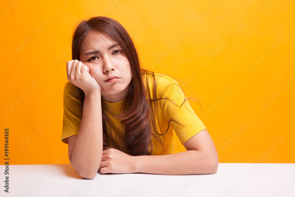 Asian girl is getting bore in yellow dress Asian girl is getting bore in yellow dress