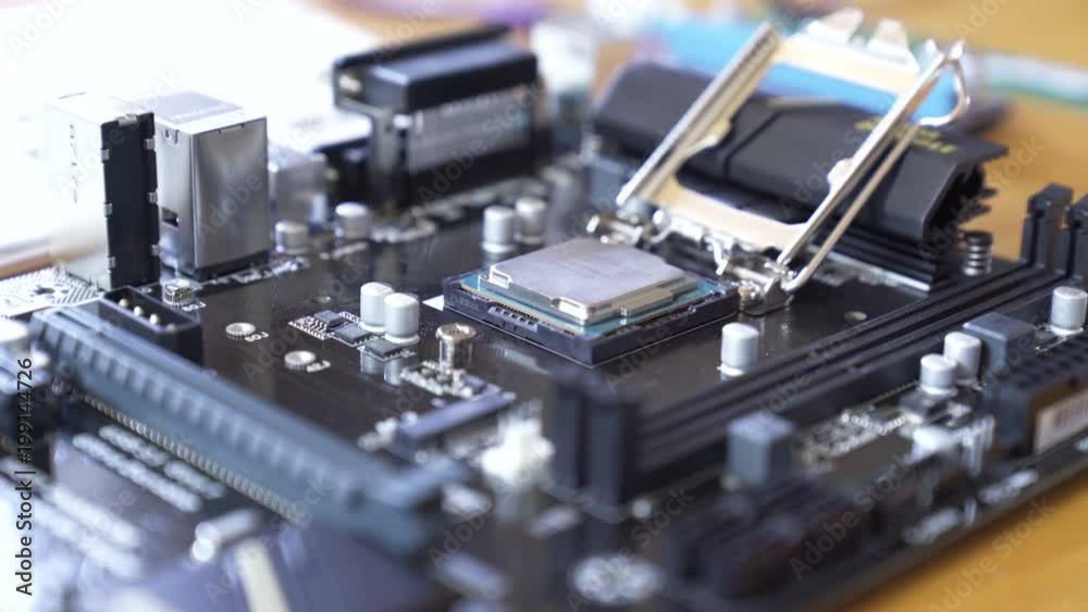 Engineer sets the CPU into the motherboard. Close up 4K shot. Engineer sets the CPU into the motherboard. Close up 4K shot.