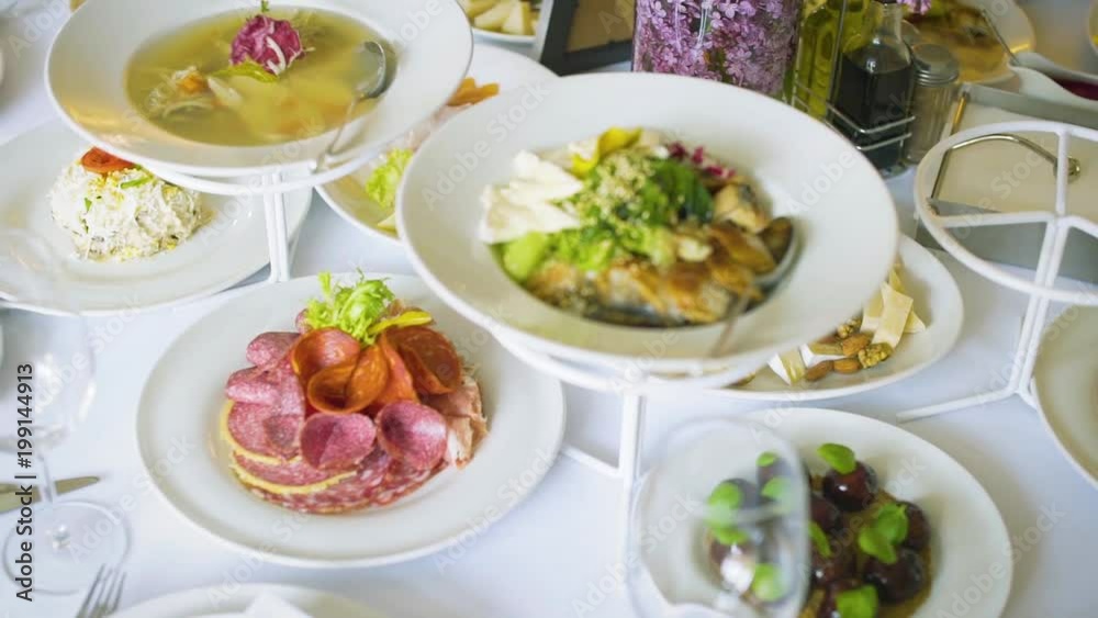 salad in white plate and appliances on a white table in a restaurant salad in white plate and appliances on a white table in a restaurant