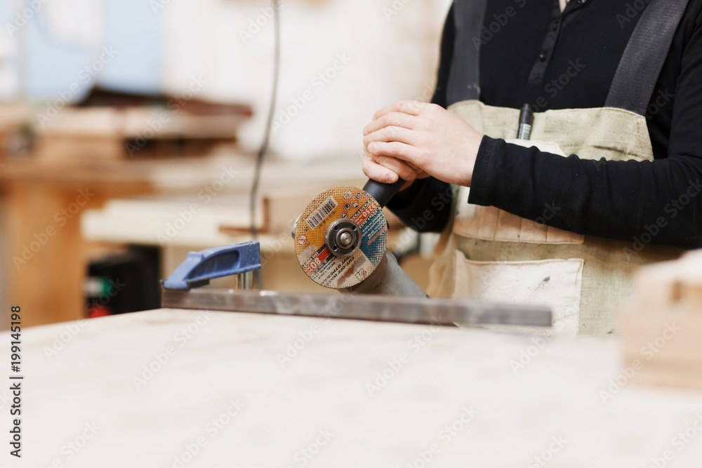 Industrial worker cutting metal with many sharp sparks. Selection focus to cutting machine. Copyspace