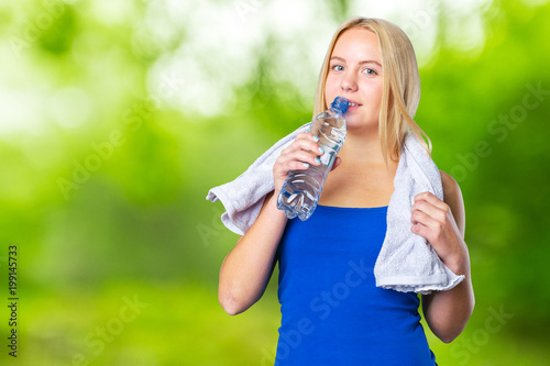 portrait of a healthy young woman drinking water