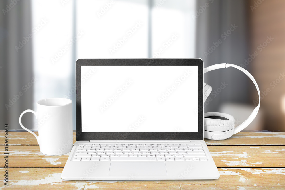 Headphones with laptop on table Headphones with laptop on table