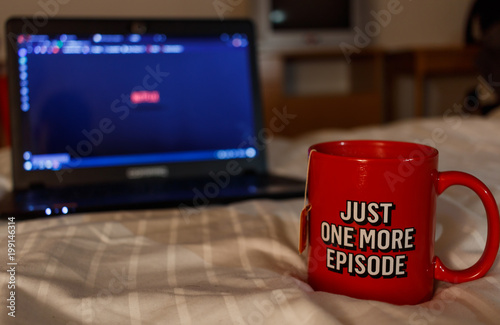 Watching series with a cup of tea. Just one more episode. Millennial concept photo