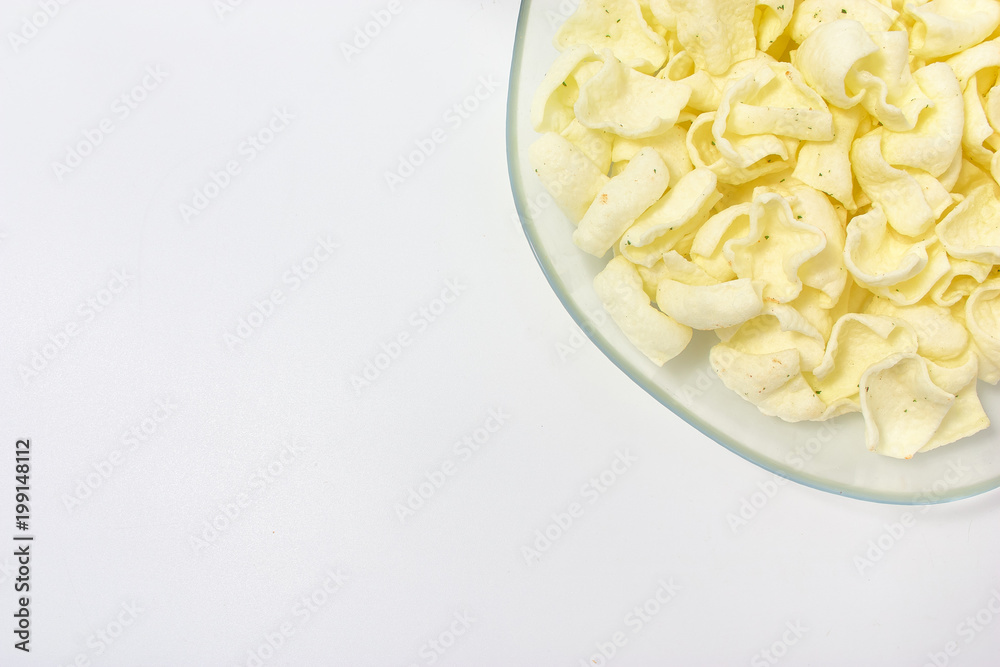 golden potato chips on a white background.