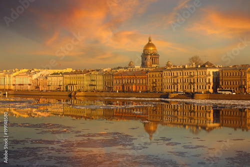 a view of the St. Isaac's Cathedral during the ice drift. Sunset on the Neva River in St. Petersburg in early spring © Lana Kray