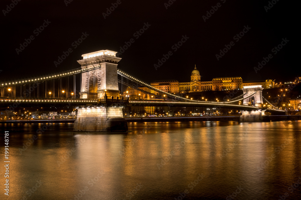 The Chain Bridge with the Royal Palace in the background in Budapest at night