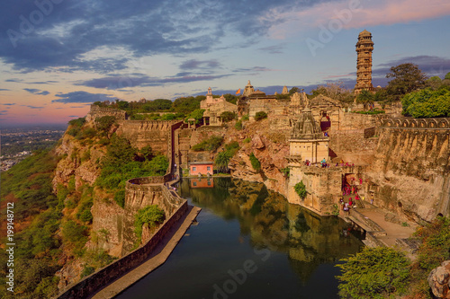 a stone fortress on the hill of fort chittorgarh in india in evening at sunset. architectural landmark photo