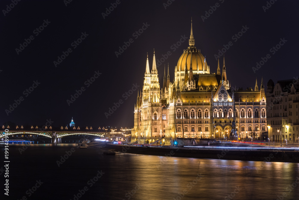 Famous Budapest parliament at the river Danube at night from the side