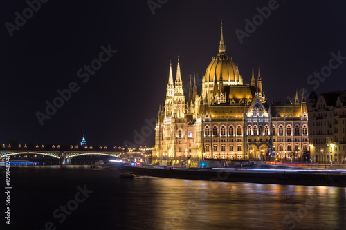 Famous Budapest parliament at the river Danube at night from the side