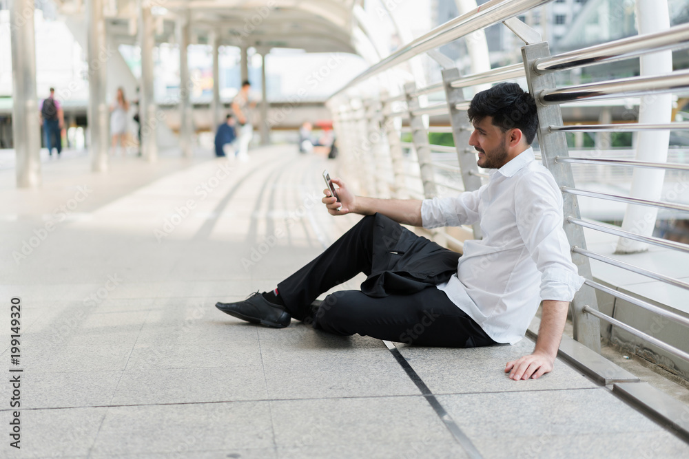 Handsome hipster modern business man using smart phone in the city. concept of communication online. Handsome hipster modern business man using smart phone in the city. concept of communication online.
