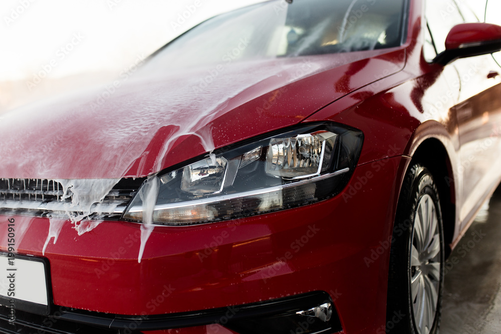 Car washing. Cleaning car using high pressure water. Selective focus. Car washing. Cleaning car using high pressure water. Selective focus.