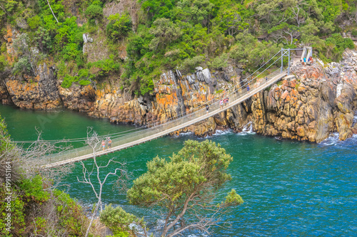 The Suspension Bridge over the Storms River Mouth within Tsitsikamma National Park, Eastern Cape, near Plettenberg Bay in South Africa. It is an important tourist destination along the Garden Route.