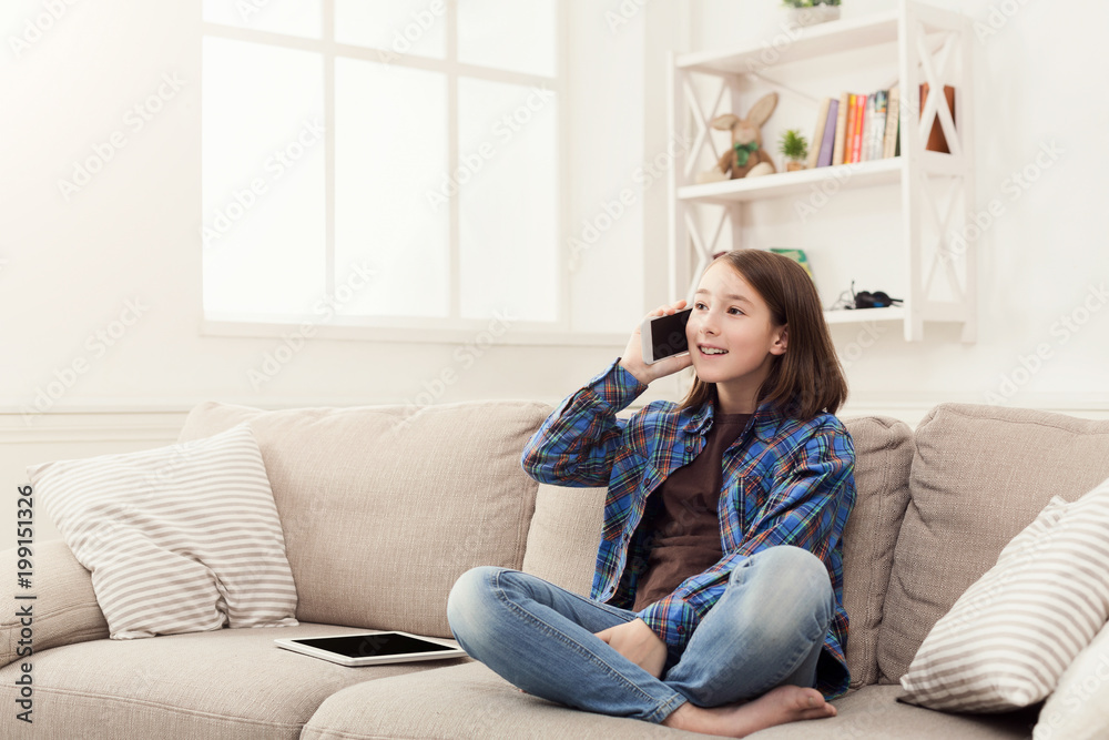 Young girl at home talking on mobile phone