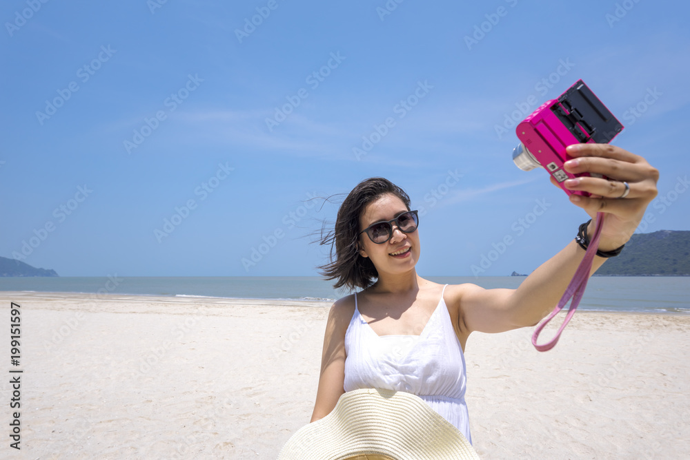 Selfie, Young Asian woman taking self portrait on the beach