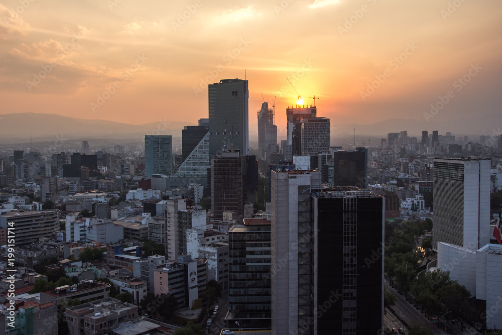 Sunset in Mexico City with a view of traffic and buildings at Paseo de la Reforma