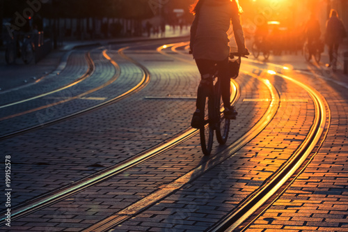 Blurred of people riding bicycle during the sunset in the city of Bordeaux in vintage style