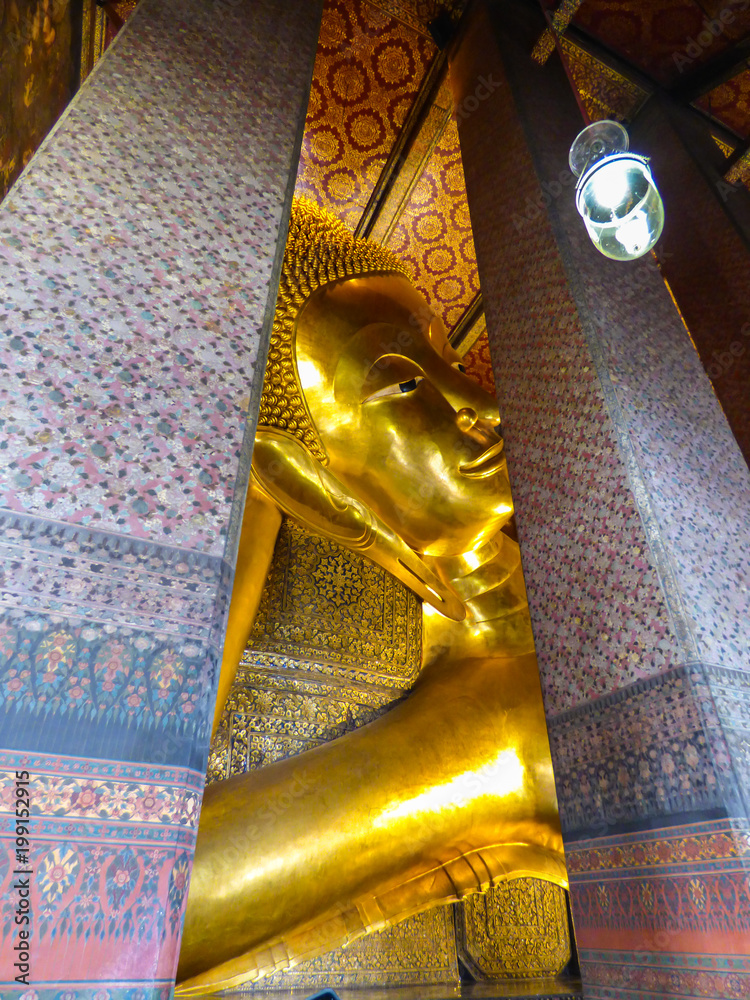 Bangkok, Thailand - Circa January 2018: Head of the big reclining Buddha at Wat Pho (Buddhist temple)