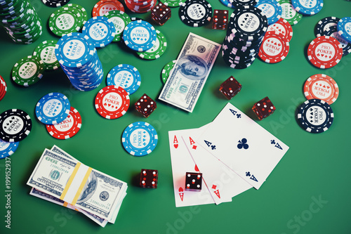 3D illustration casino game. Chips, playing cards for poker. Poker chips, red dice and money on green table. Online casino concept. photo