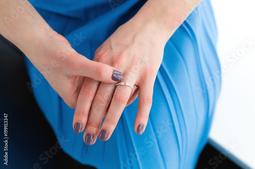 Woman wearing an engagement ring © Tinatin
