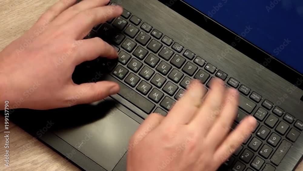 Caucasian man hands printing on laptop keyboard. Closeup view of computer on the table. Office scene. Top view. Caucasian man hands printing on laptop keyboard. Closeup view of computer on the table. Office scene. Top view.