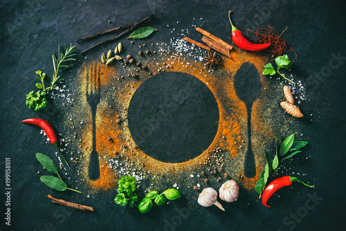 Obraz na płótnie Herbs and spices on table with cutlery silhouette