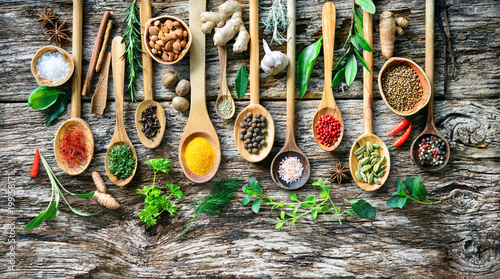 Various herbs and spices for cooking on old wooden board